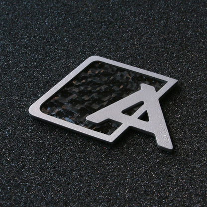 Carbon fiber Audi trunk badge upgrade by CHIMERA STUDIO, featuring sleek, modern design for a stylish vehicle enhancement.