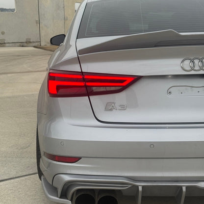Back view of a silver Audi A3 car with visible Audi logo.