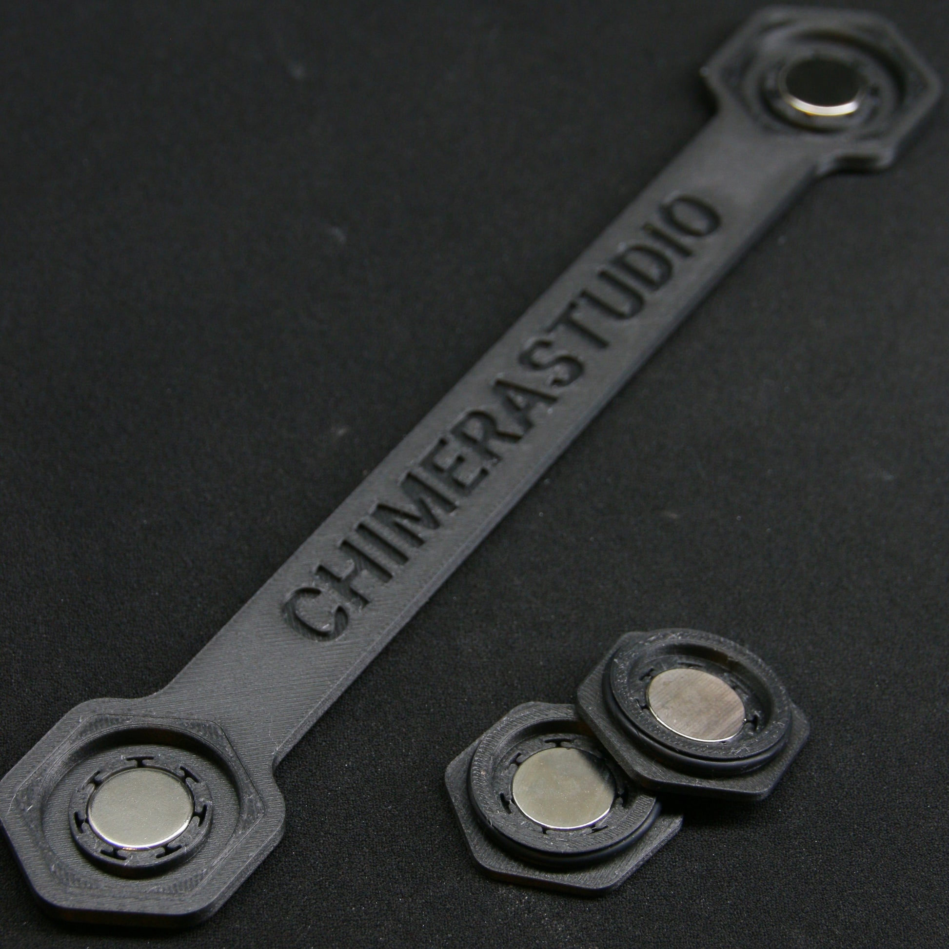 V2 Magnetic License Plate Bracket by CHIMERA STUDIO mounted on a car showing the easy-to-attach magnetic design